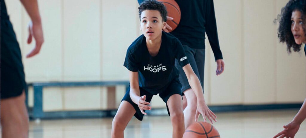young boy in basketball training