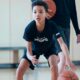 young boy in basketball training
